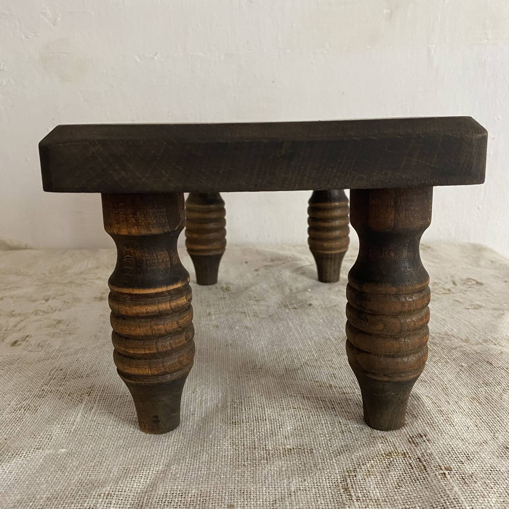 Low stool, turned wooden legs.