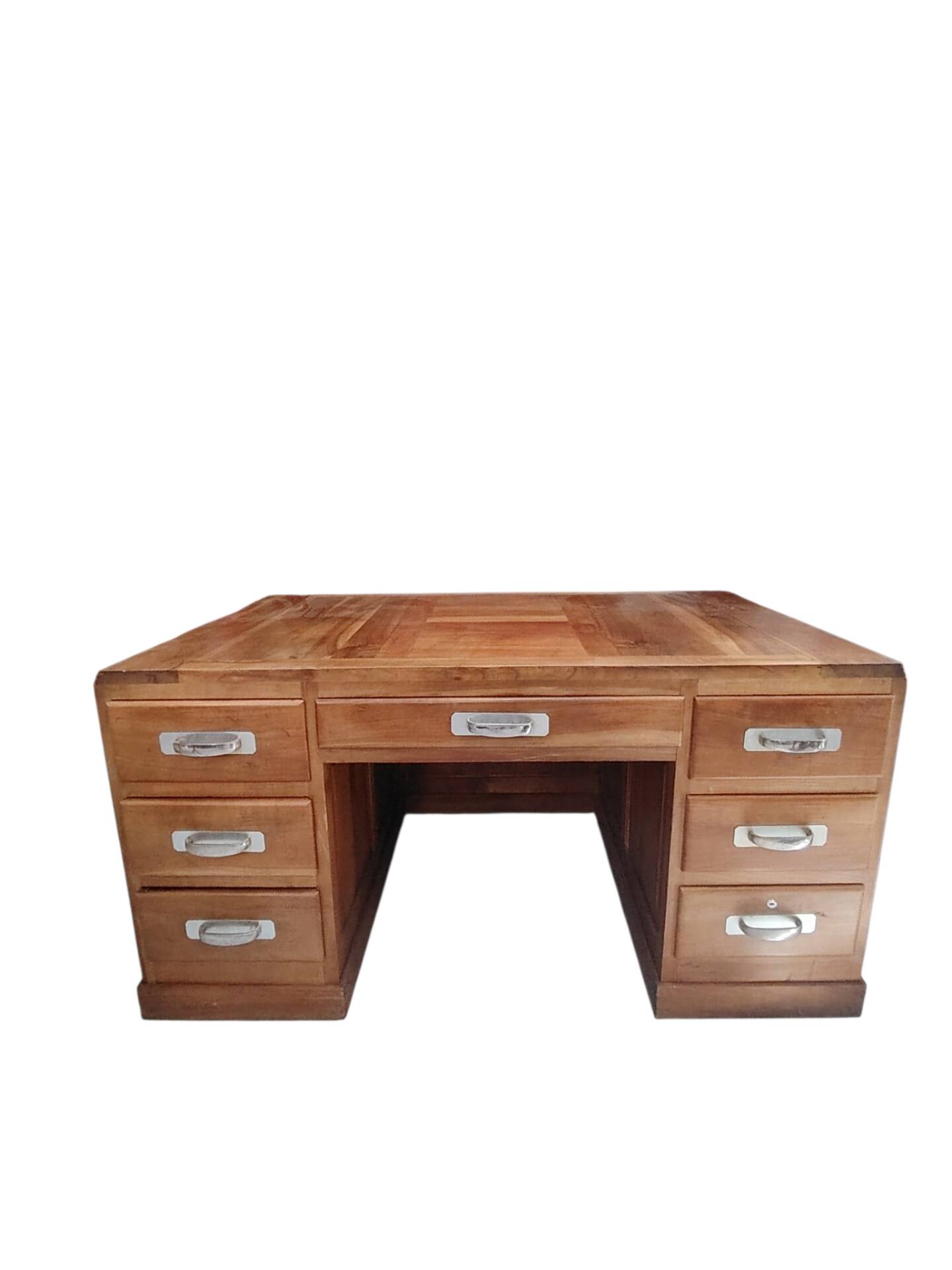 Large modernist minister's desk in solid lemon wood with 7 drawers.