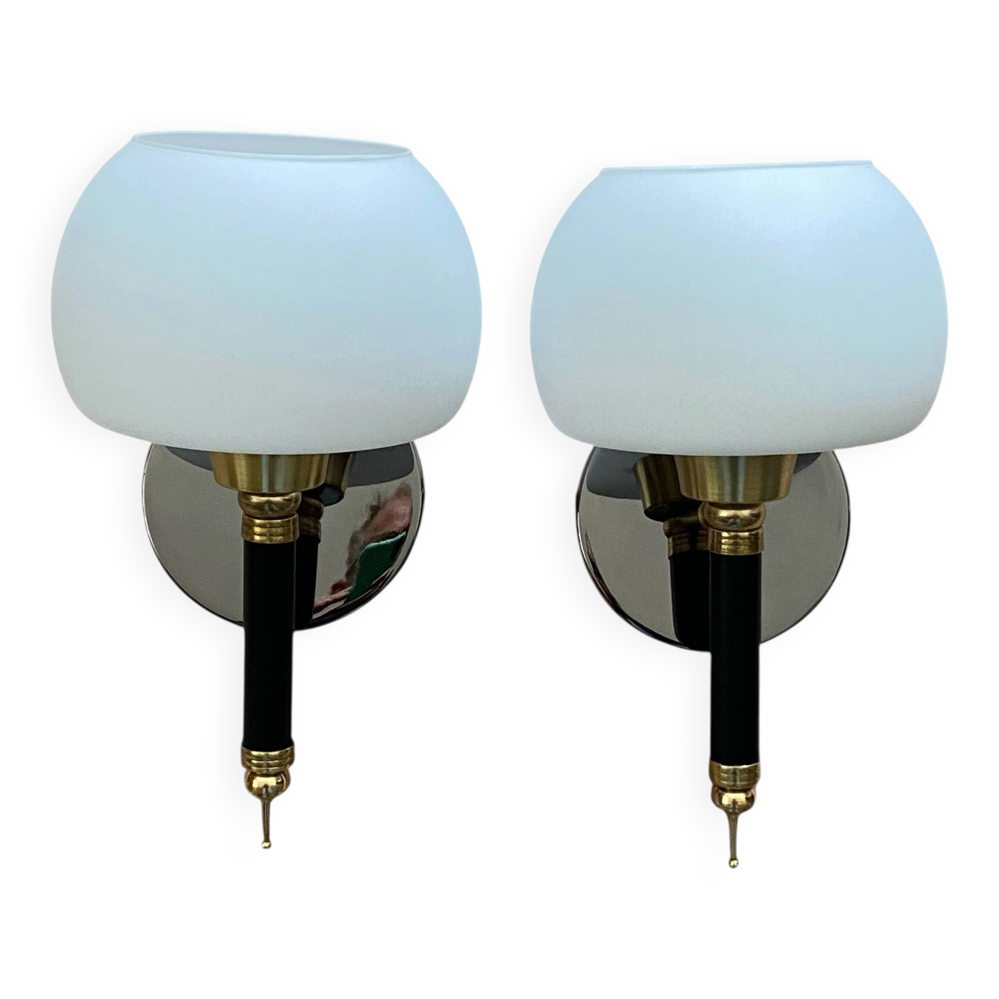 Pair of wall sconces with brass torch and white glass globe.
