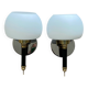 Pair of wall sconces with brass torch and white glass globe.