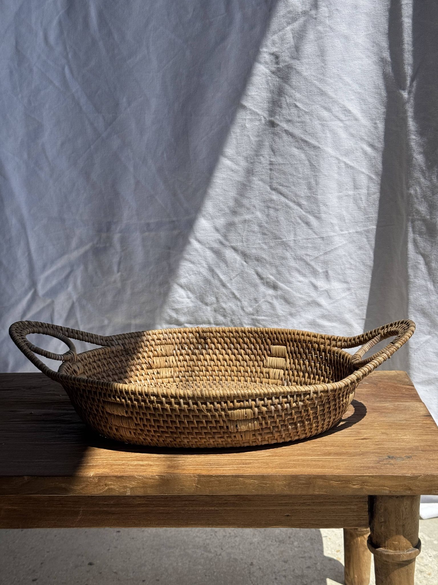 Large flat oval woven rattan basket with handles, Indonesian L53x64