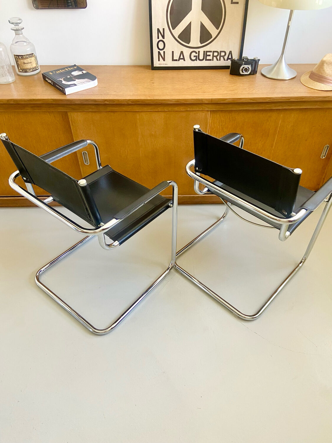 Pair of vintage chrome and black faux leather armchairs