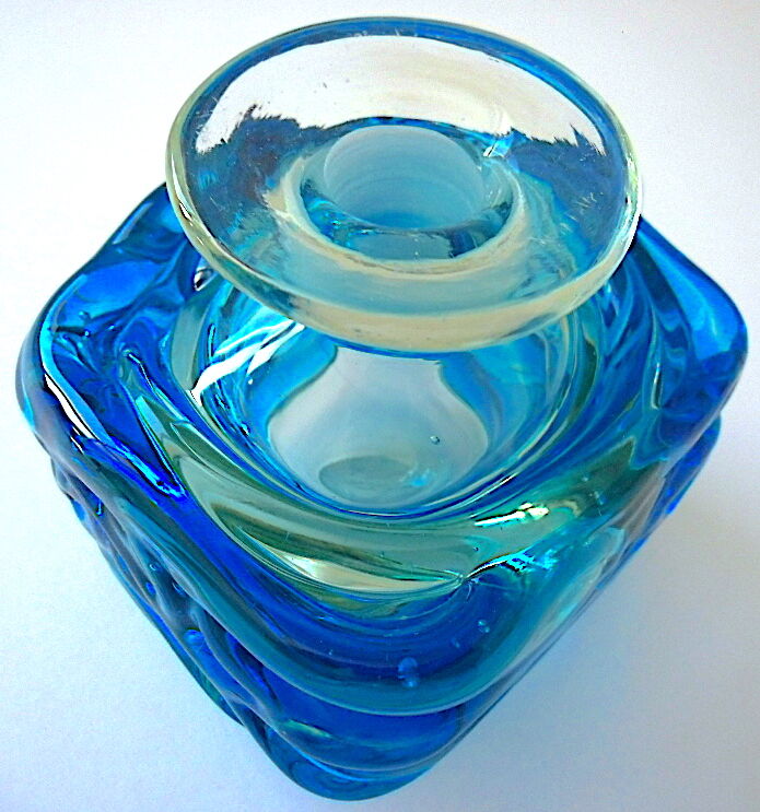 Blown blue glass bottle with inclusions
