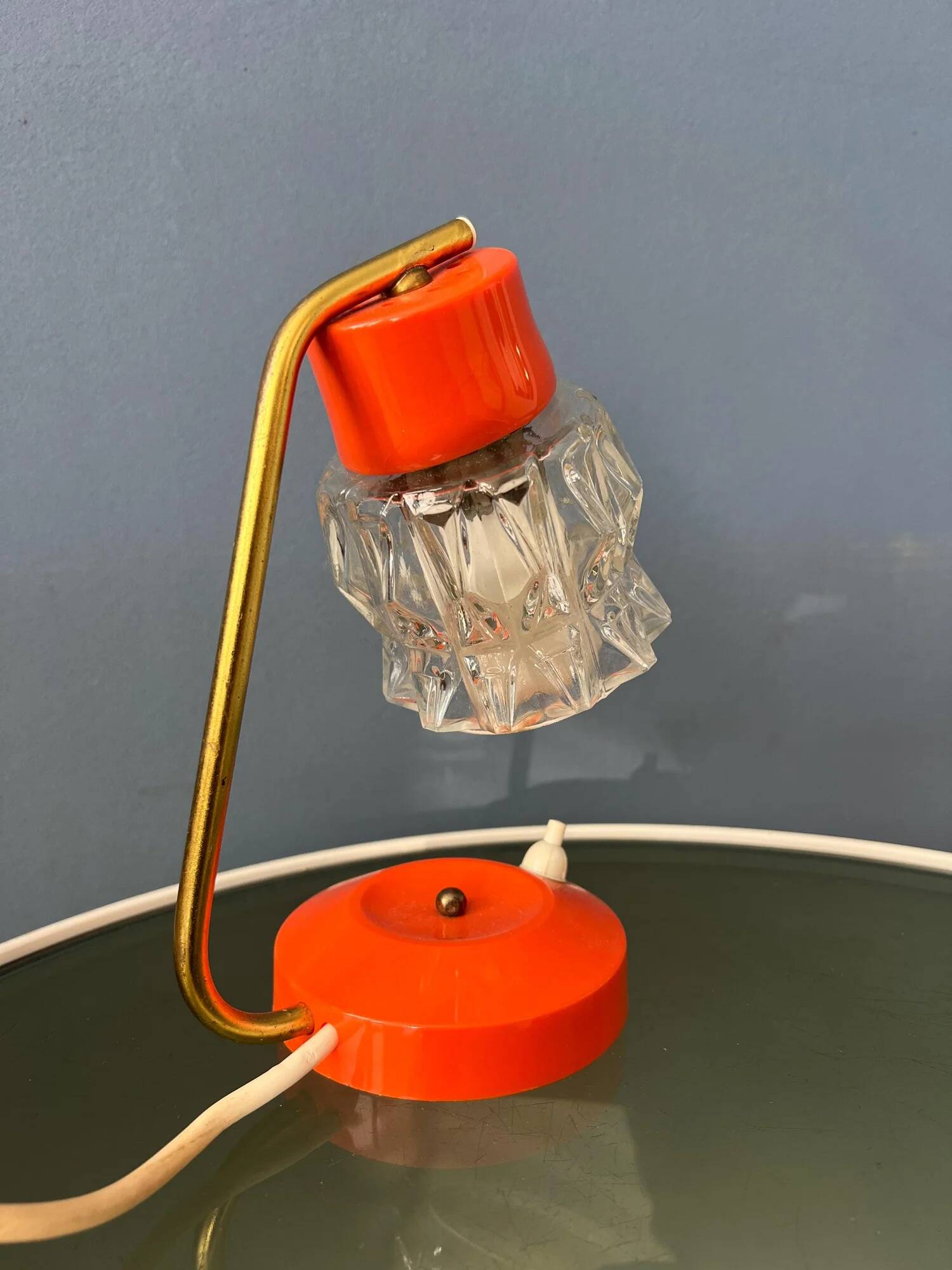 Small orange desk lamp with clear crystal glass shade