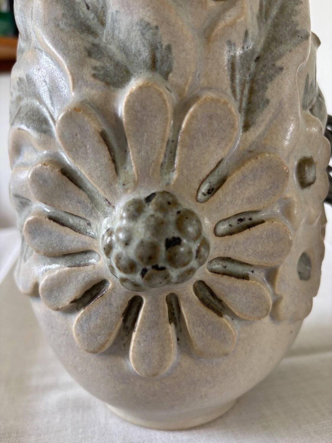 Pair of white glazed stoneware lamp bases, 20th-century floral decoration.