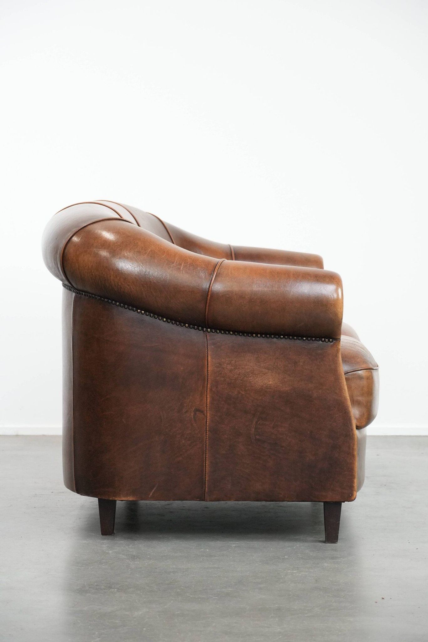 Characterful vintage sturdy 2-seater club sofa made of sheepskin leather