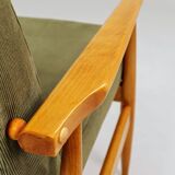 Mid-century modern design armchair in olive green corduroy.