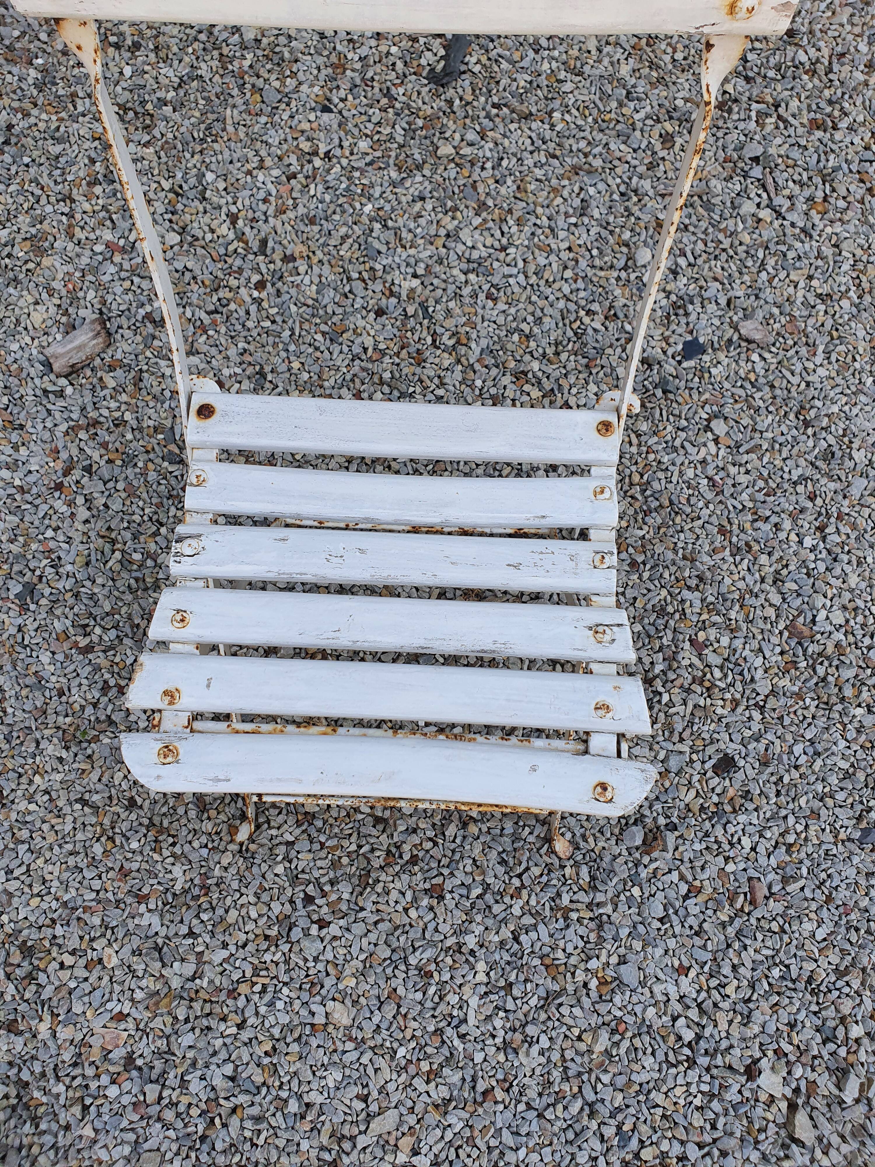 Wooden slatted garden chair with wooden slats and iron feet