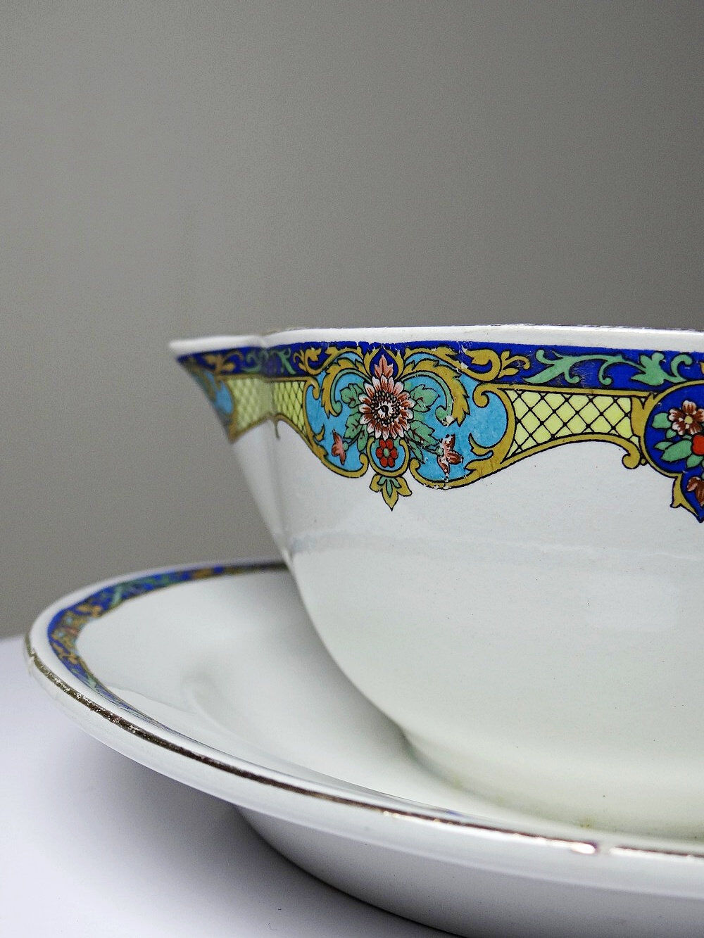 Old Lunéville sauce boat, opaque porcelain with polychrome decoration.