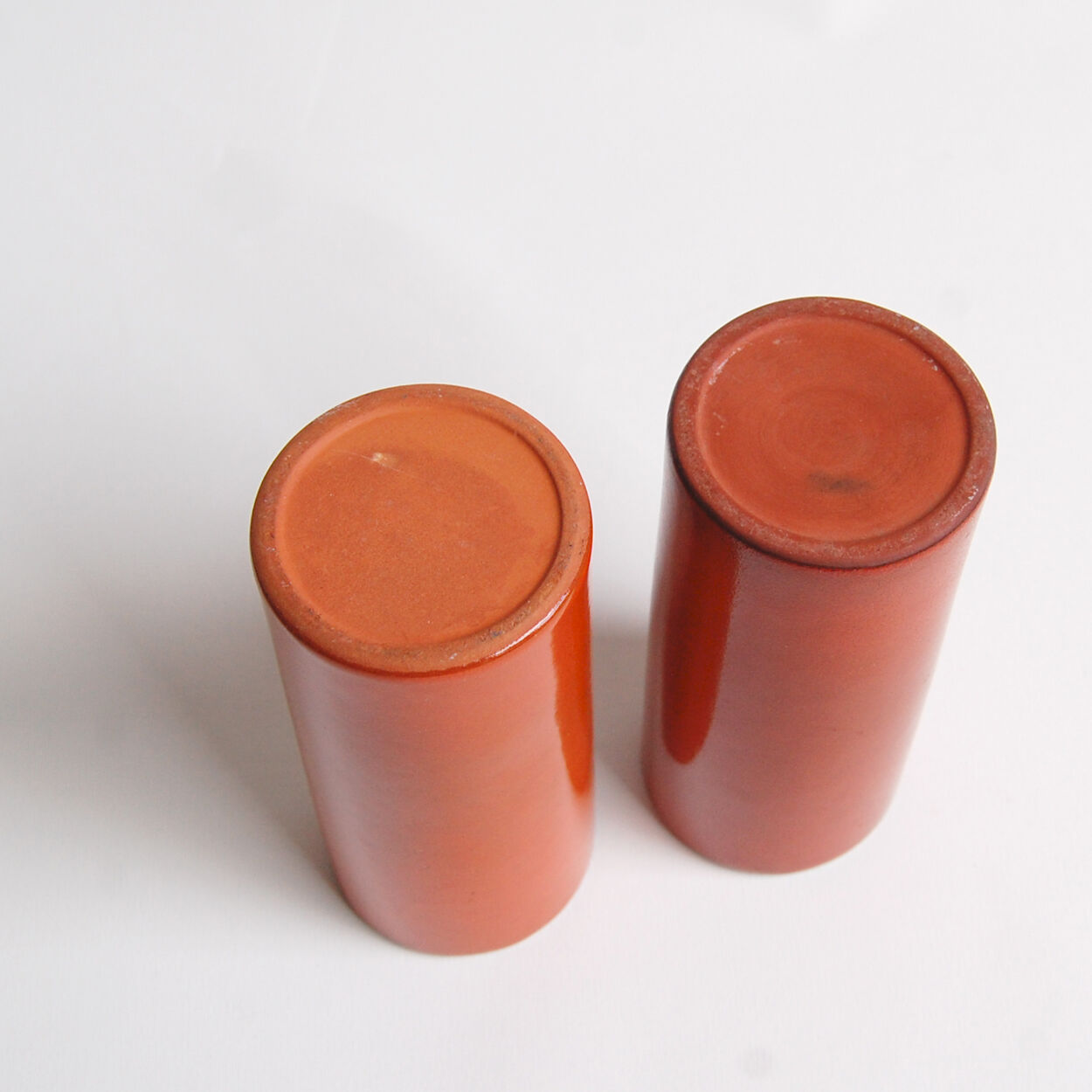 Pair of orange roll vases
