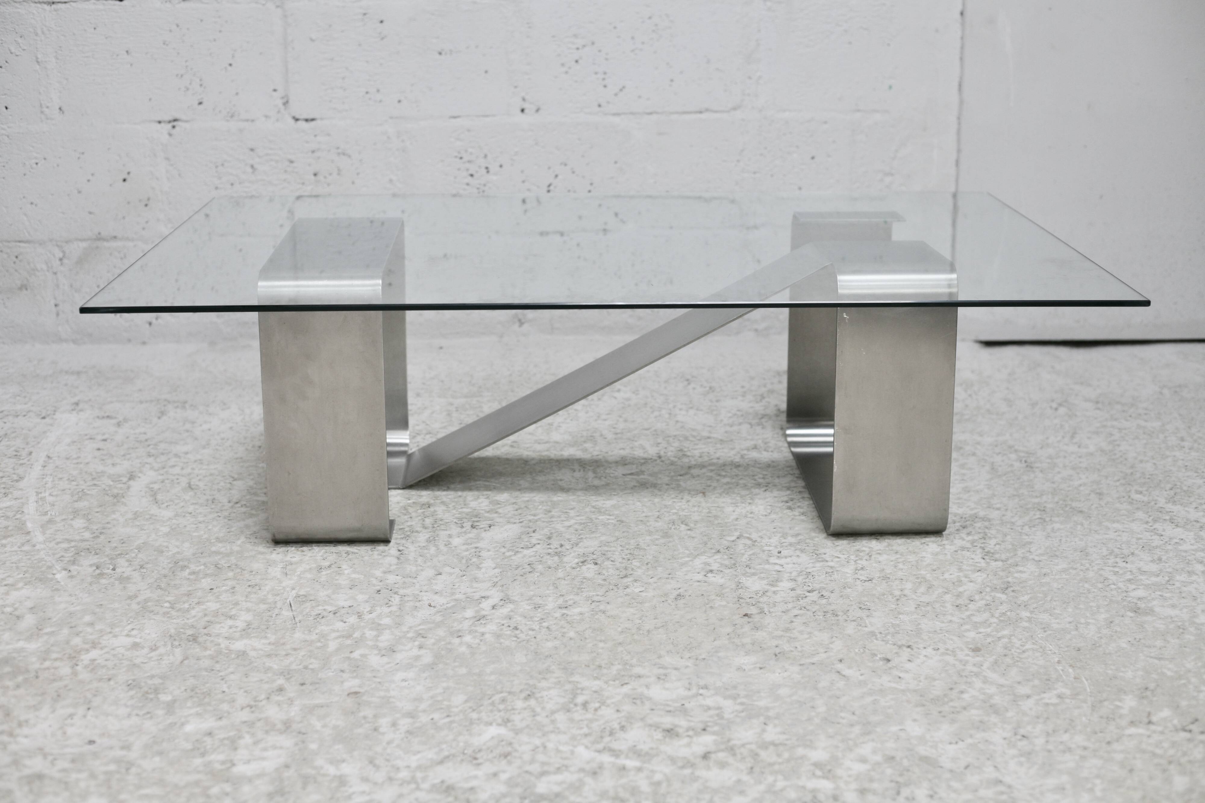 Coffee table with "kinetic" steel base and glass slab. Circa 1970.