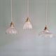 Trio of Art Deco scalloped clear glass pendant lights, 1920-30