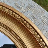Antique oval mirror in gilded stucco with gold leaf, 19th century