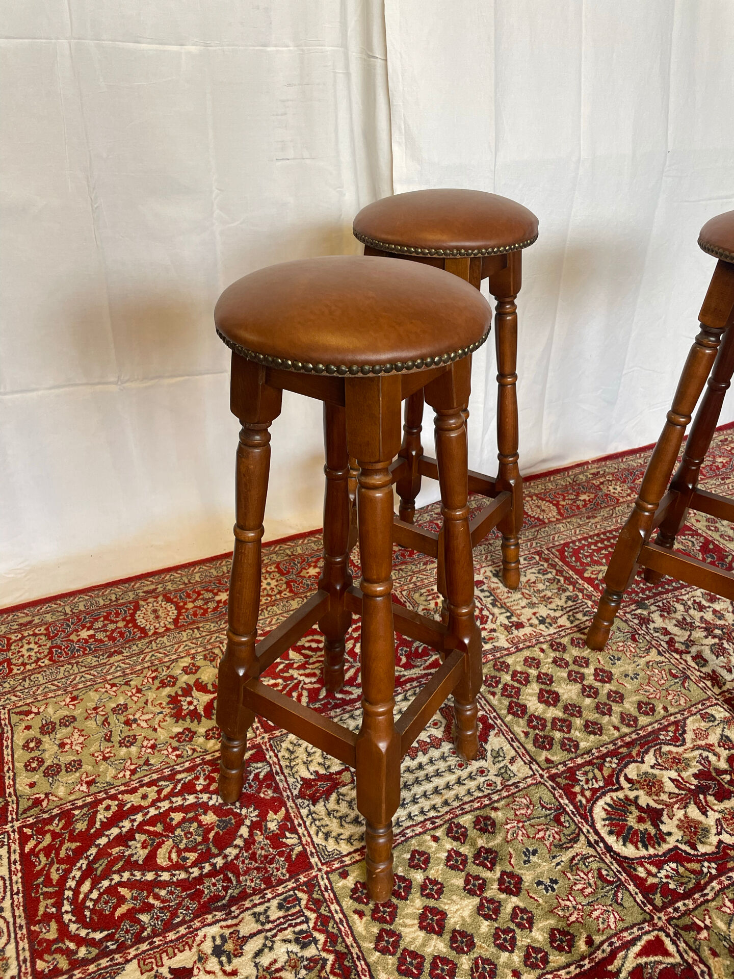 Set of 3 antique wooden and leather bar stools.