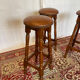 Set of 3 antique wooden and leather bar stools.