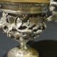 Carved silver bronze vase mounted on marble pedestal