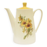 Old glazed ceramic coffee pot decorated with sunflowers
