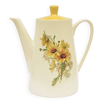 Old glazed ceramic coffee pot decorated with sunflowers