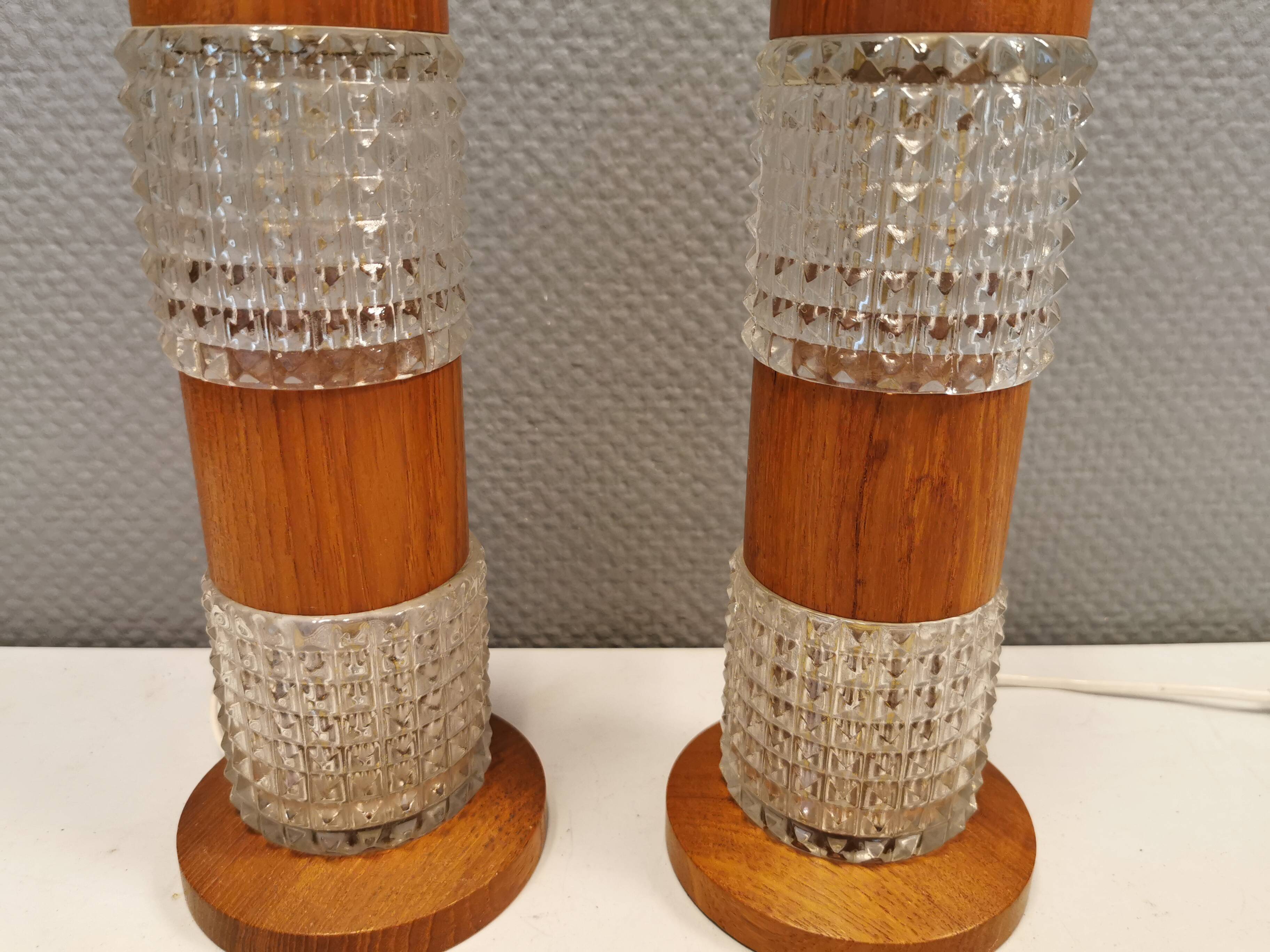 Swedish table lamps made of teak wood and hard pressed crystal glass.