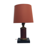 Brass lamp surrounded by leather with lampshade