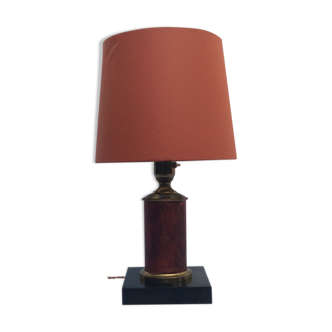 Brass lamp surrounded by leather with lampshade
