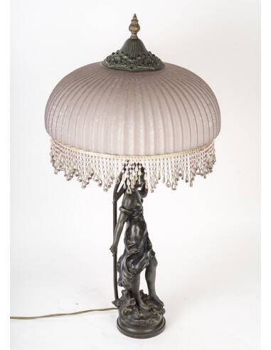 Art Nouveau style lamp with bronze sculpture and glass shade