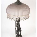 Art Nouveau style lamp with bronze sculpture and glass shade