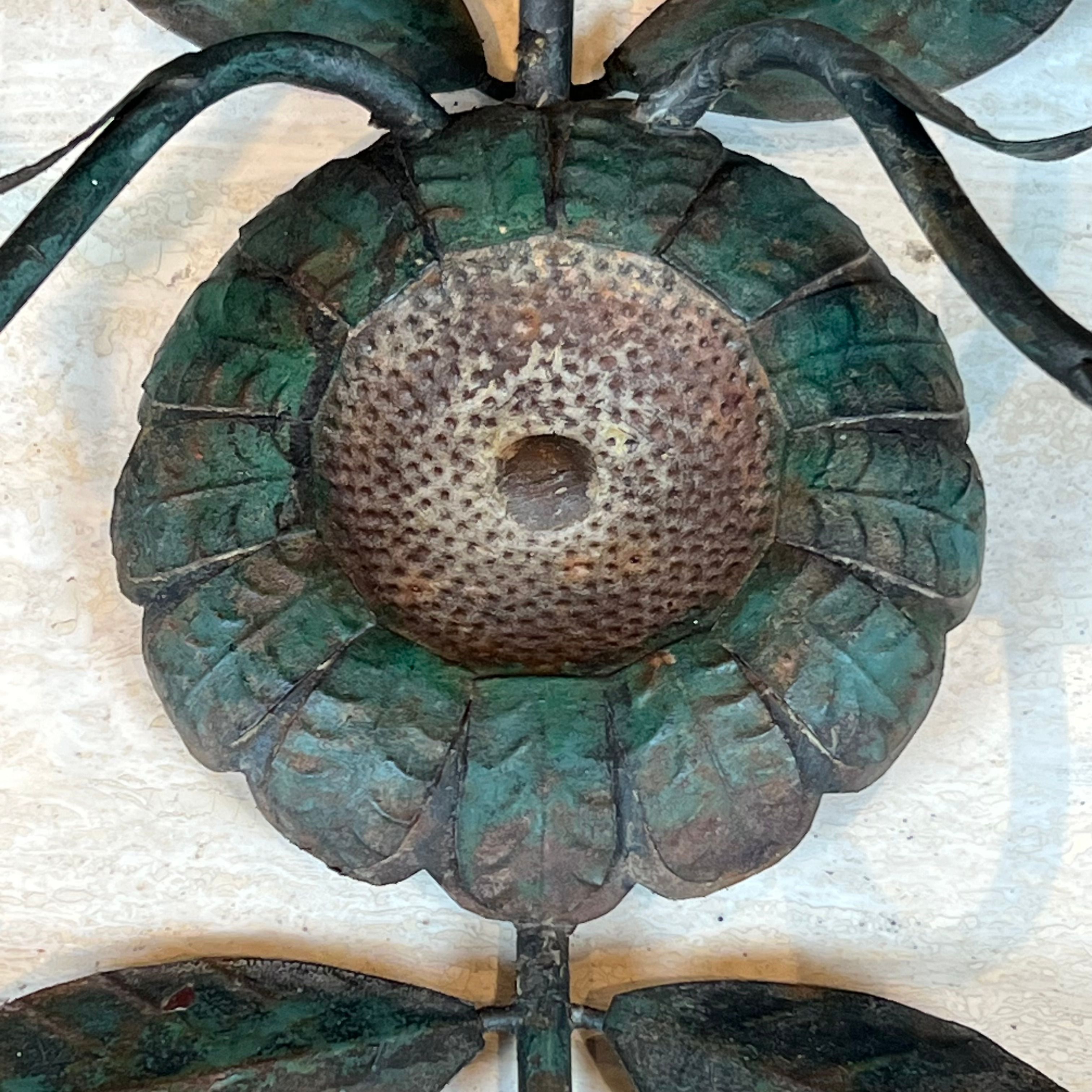 Pair of decorative wall sconces with sunflowers and patinated metal foliage.