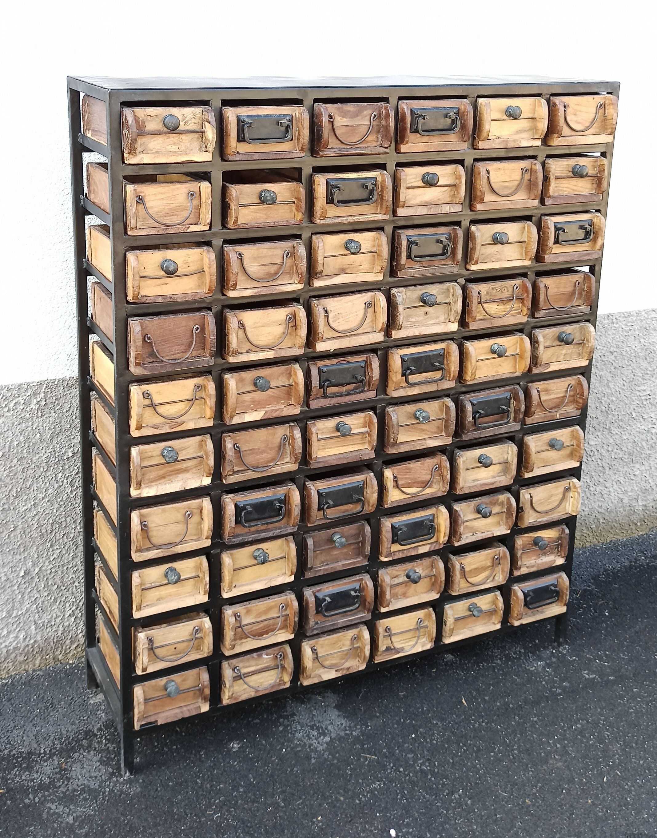 Black metal storage cabinet with 60 wooden drawers
