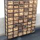 Black metal storage cabinet with 60 wooden drawers