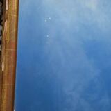 Large gilded wooden mirror in the shape of a gendarme hat