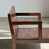Small low armchair in varnished brown wood