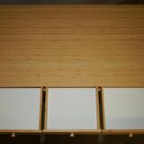 Small bamboo desk with three drawers.