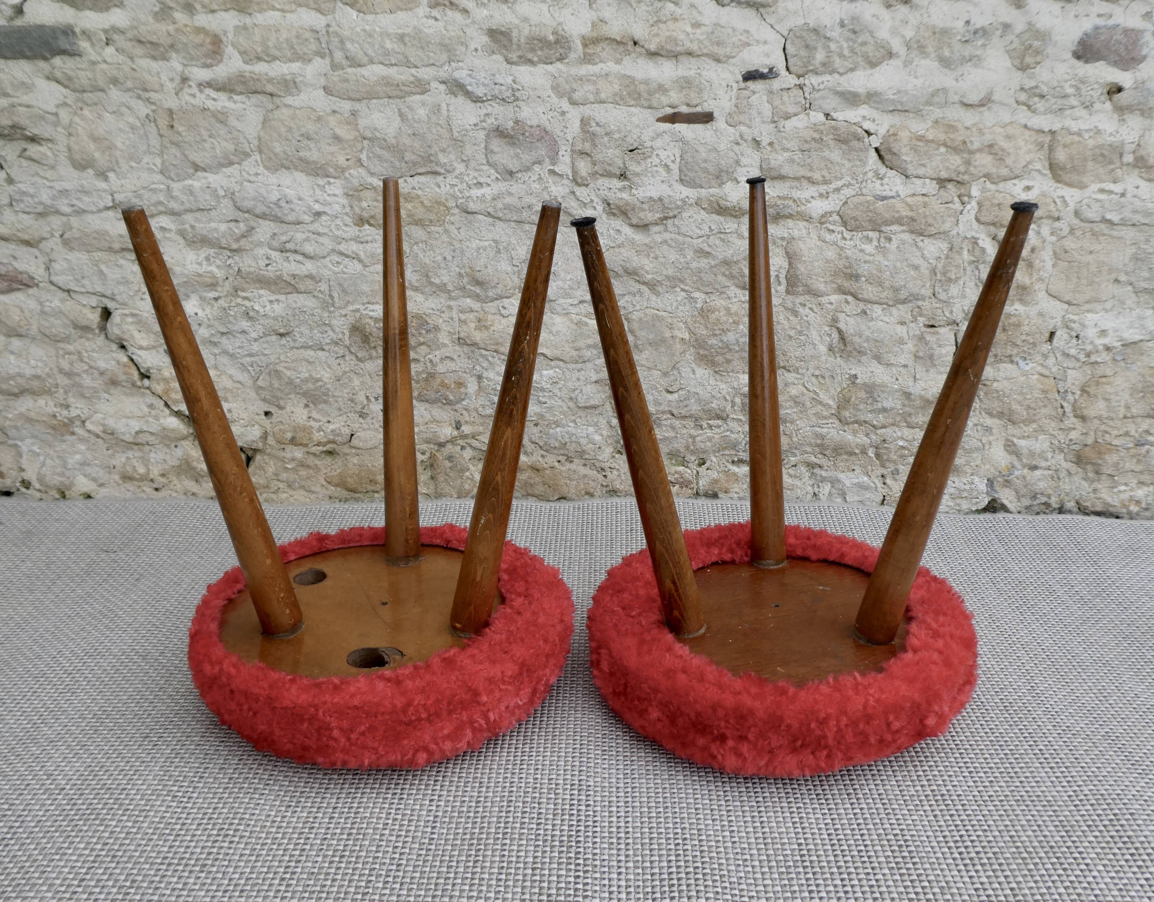 Pair of tripod stools, with tapered wooden feet and moumoute seat