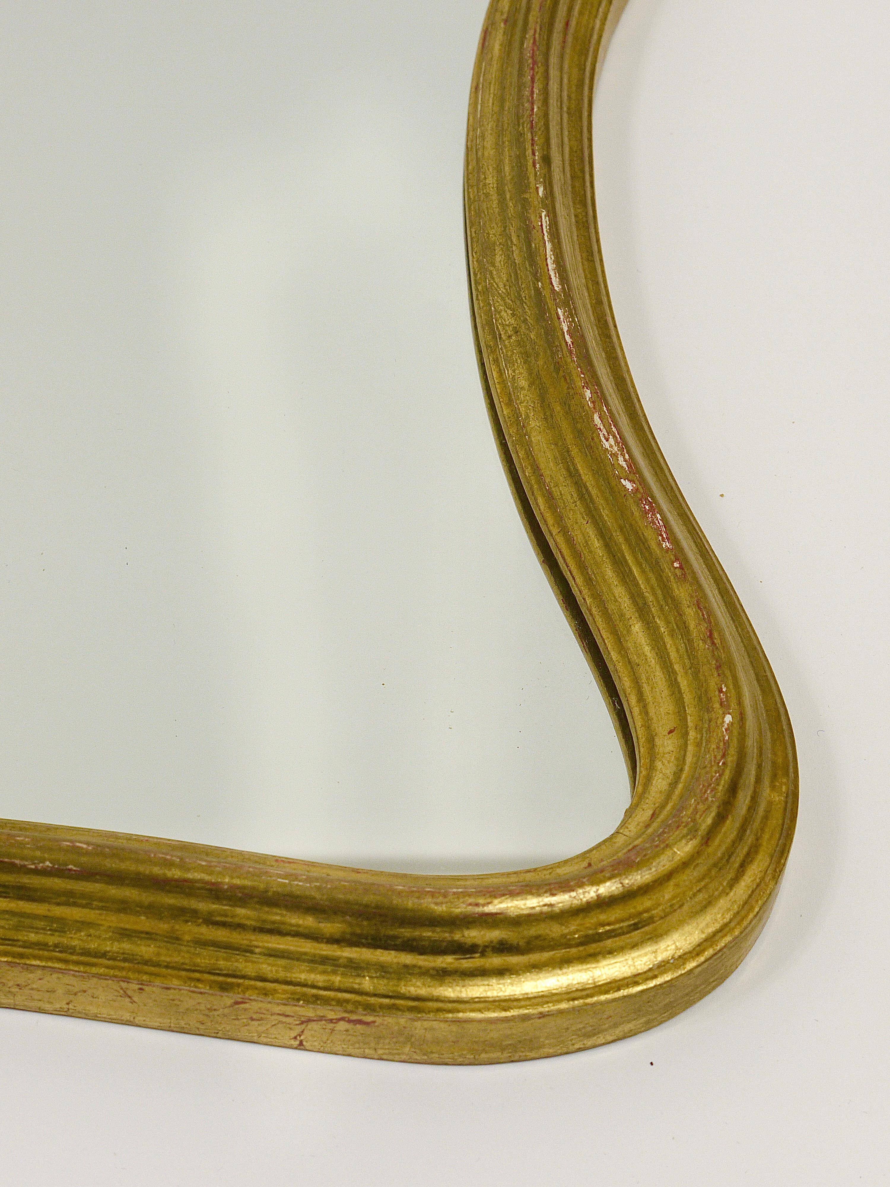 Curved wall mirror in gilded wood Chelini Firenze, mid-century, Italy, 1950s.