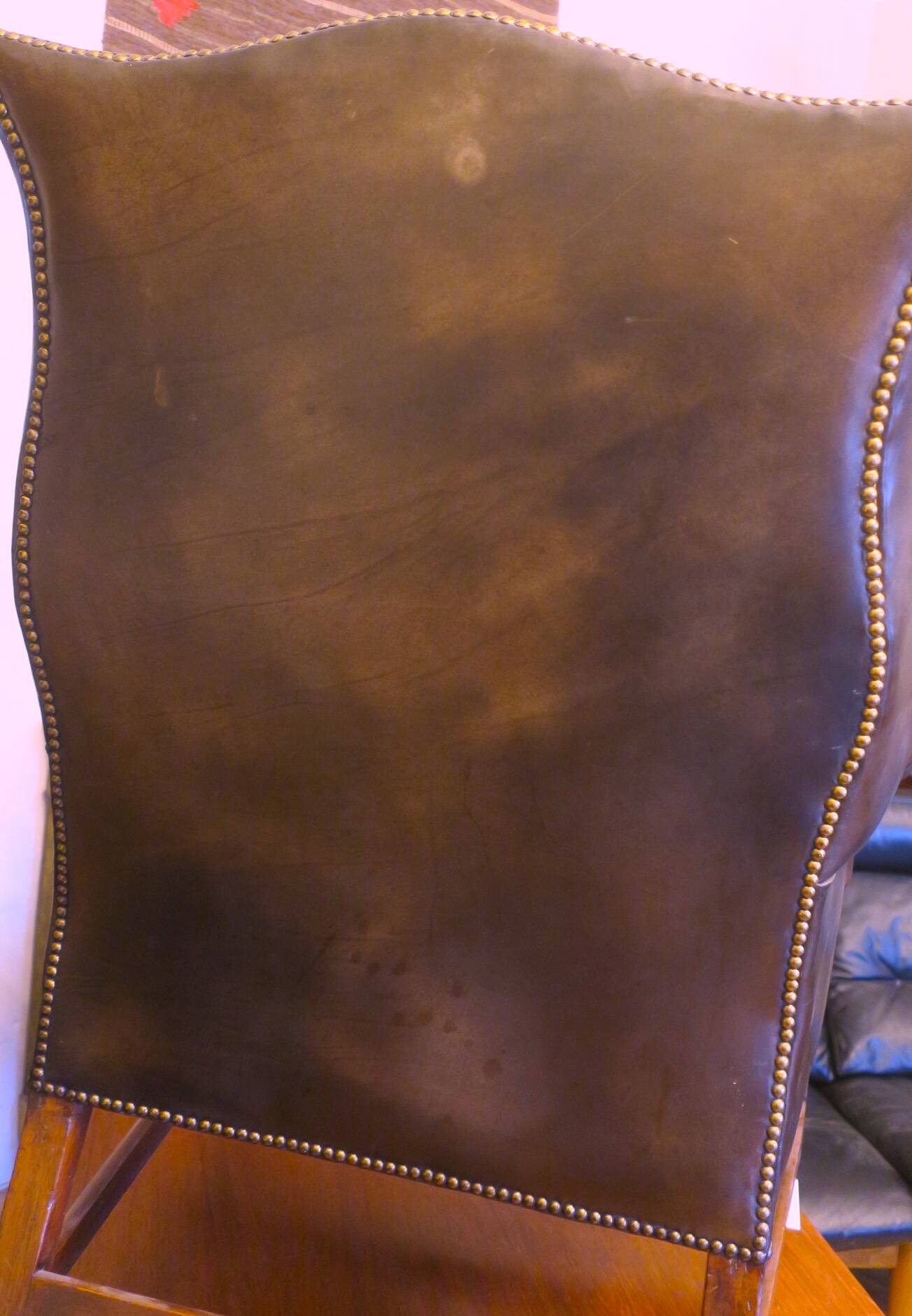 Wingback armchair in dark brown patinated leather, 1970s