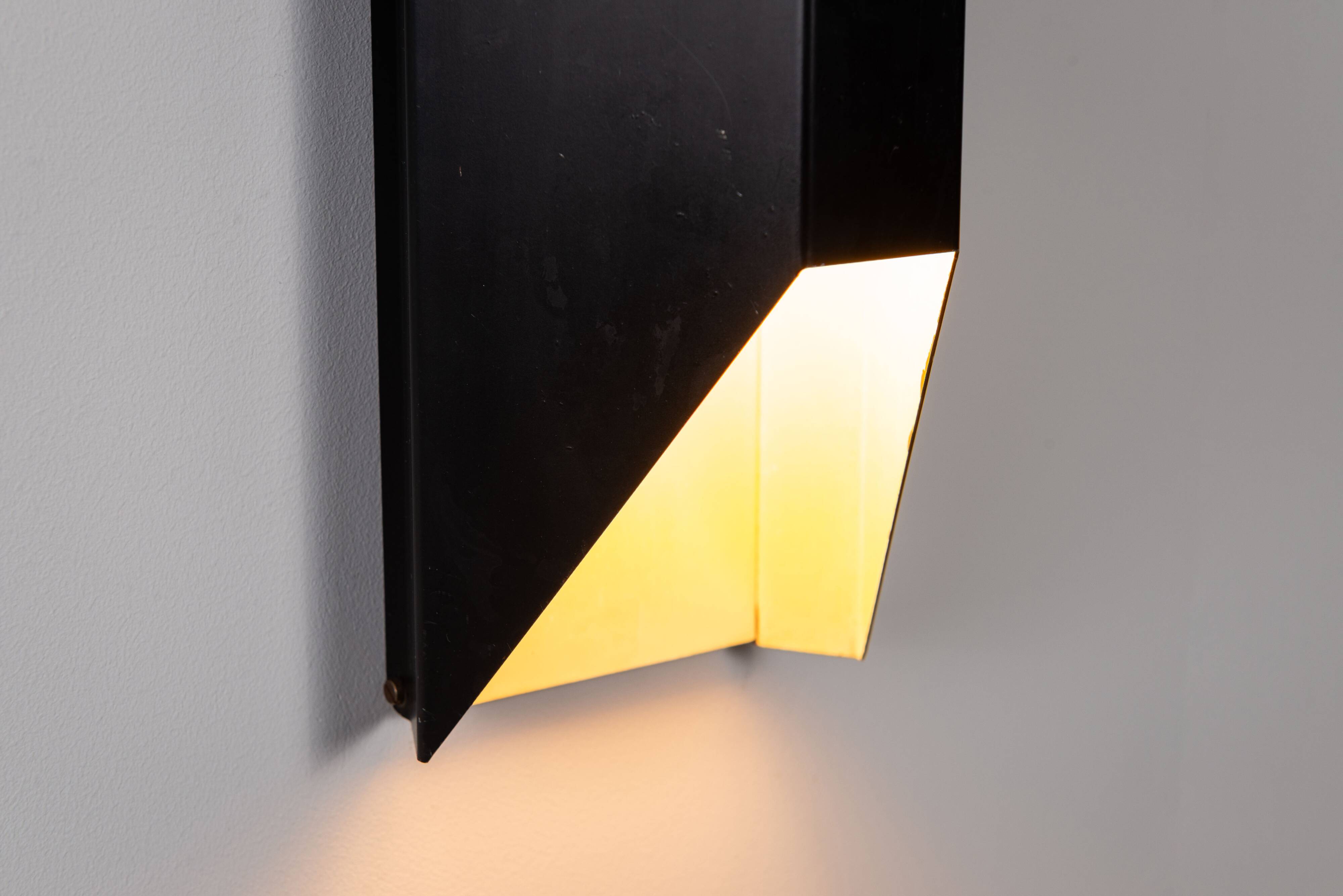 Architectural pair of vintage black metal wall lamps with angular geometric