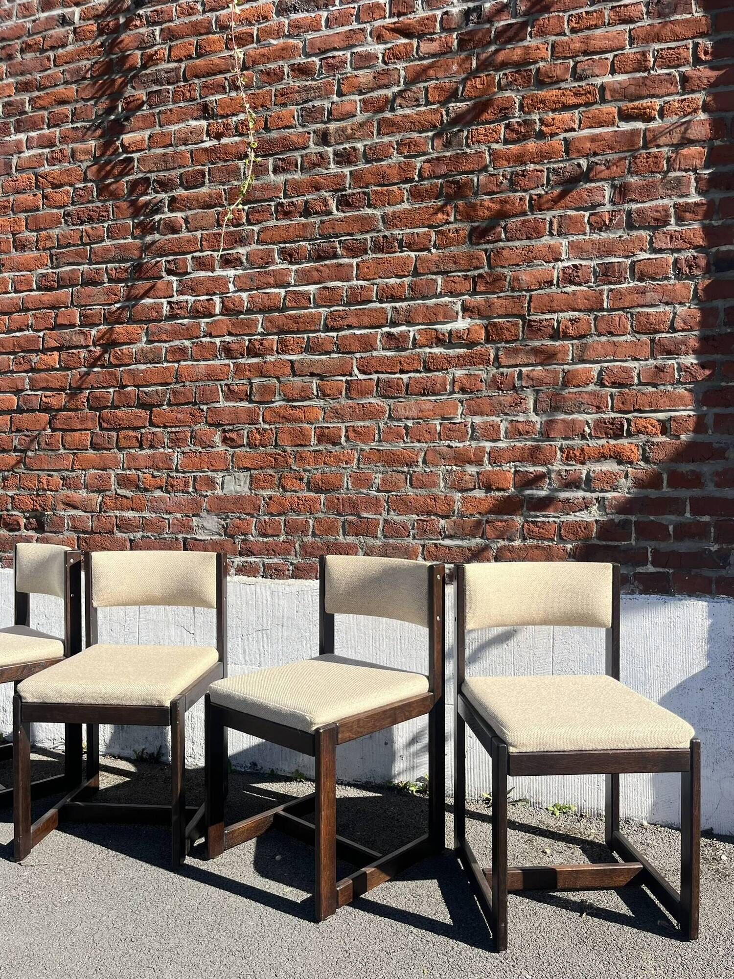 Many mid-century vintage wooden and fabric chairs.