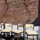 Many mid-century vintage wooden and fabric chairs.