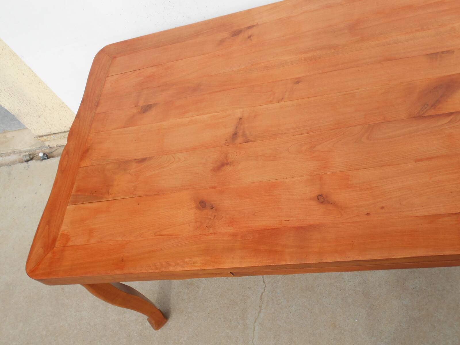 Large solid wood table with integrated extensions.