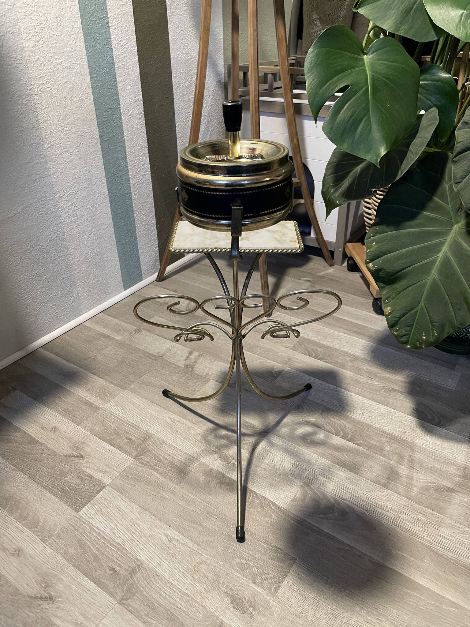 Gold wrought iron ashtray on legs with magazine rack and marbled shelf