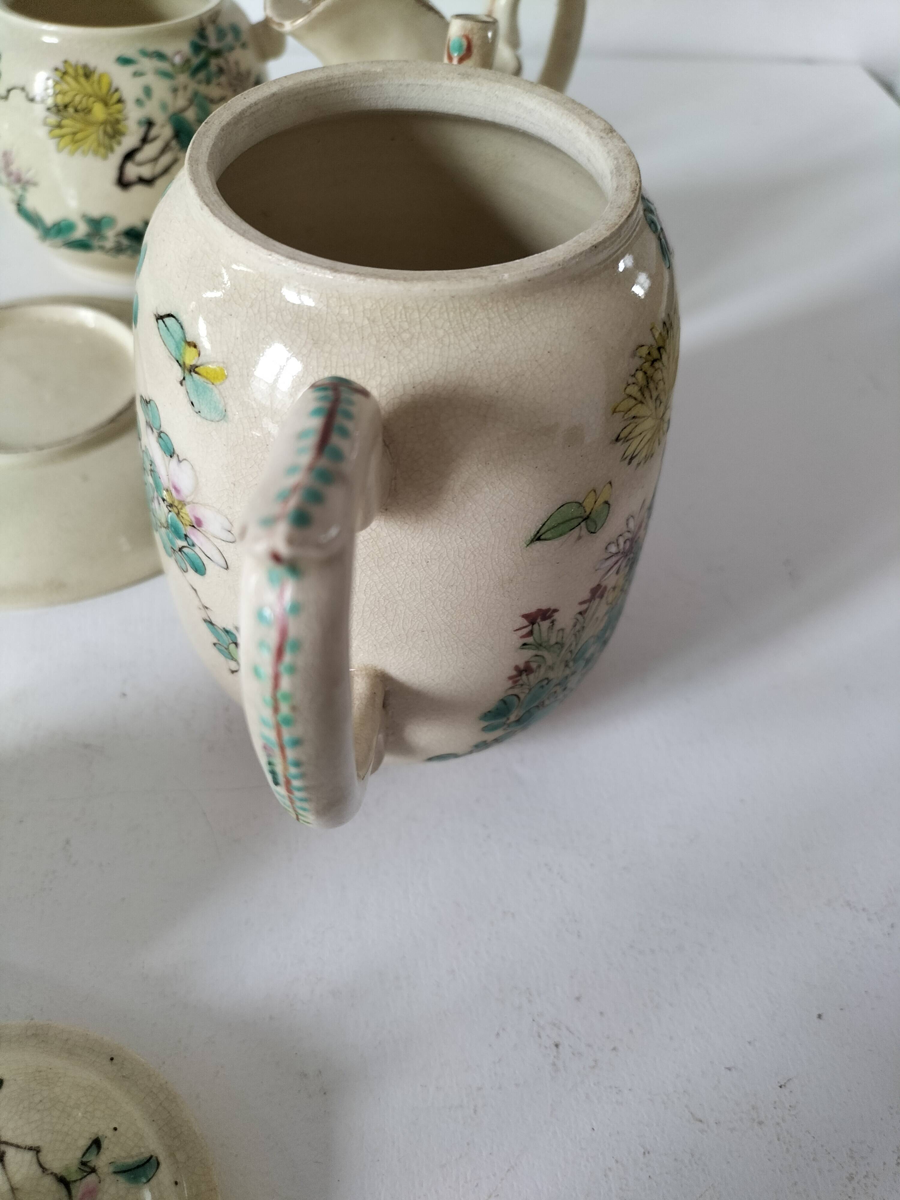 Japanese-style tea set in cracked earthenware with chrysanthemum flowers