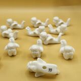 12 porte-couteaux vintage en porcelaine figurant des chérubins