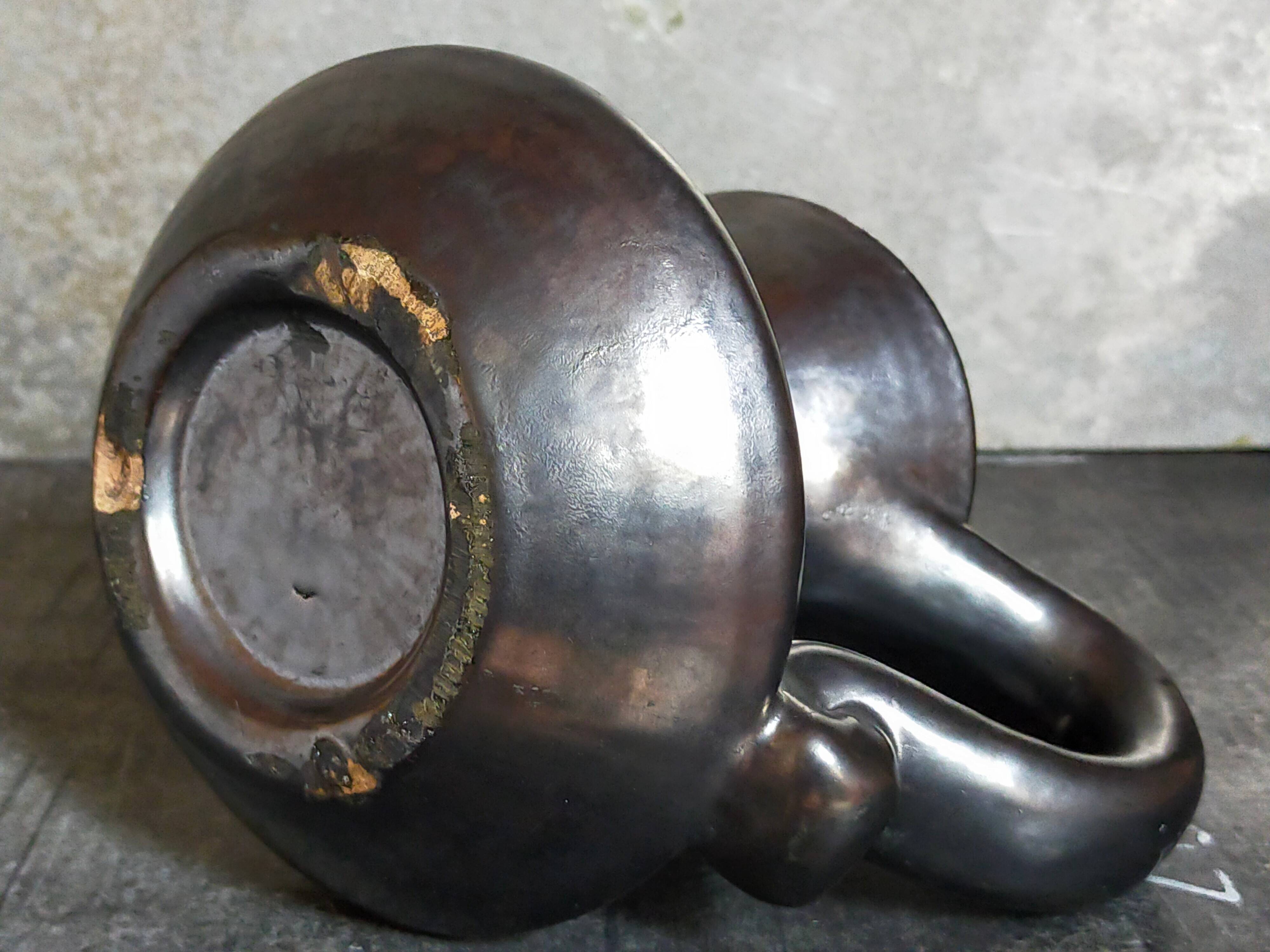 1950s iridescent black ceramic hand candle holder