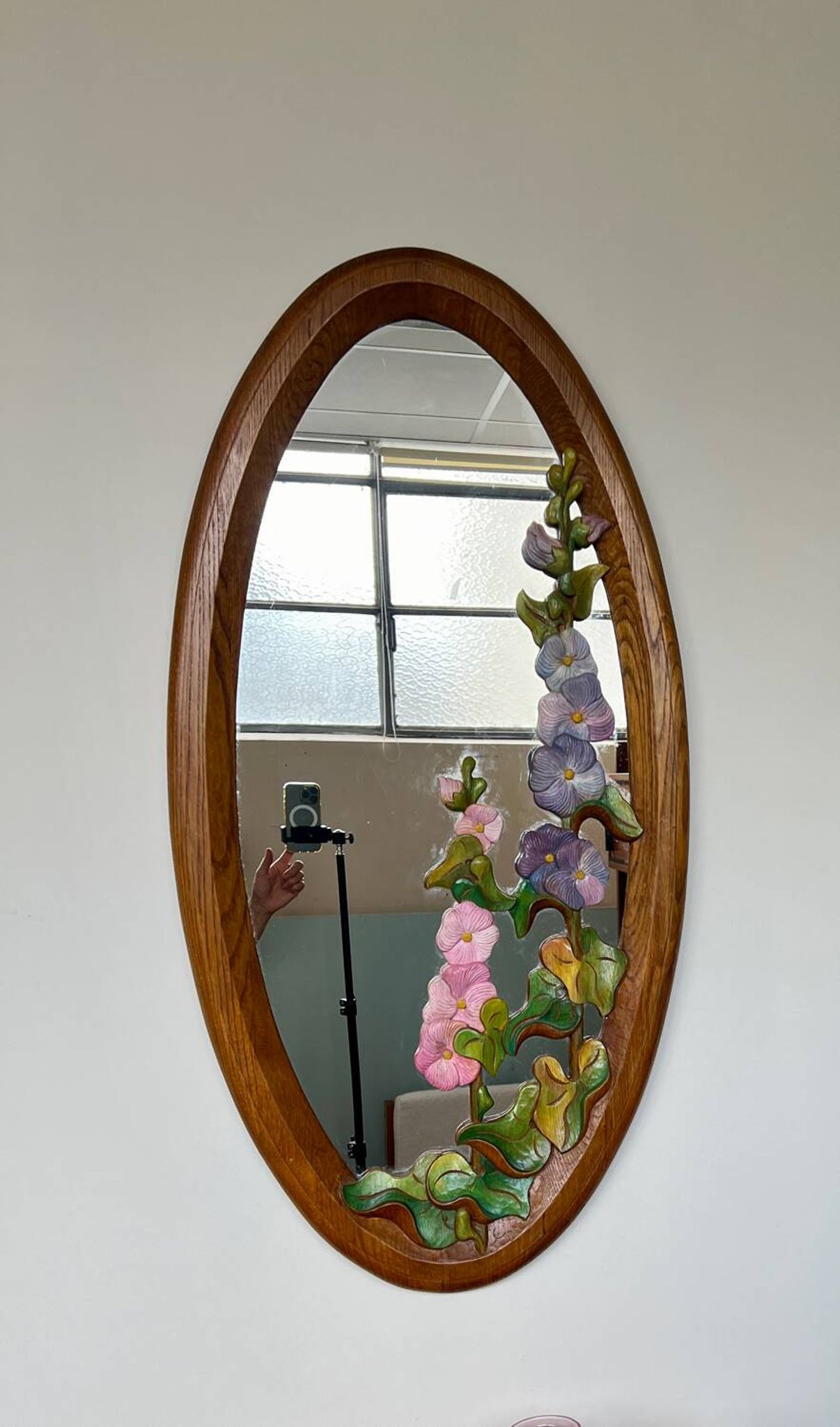 Carved wooden mirror with flower decorations.