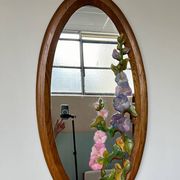 Carved wooden mirror with flower decorations.