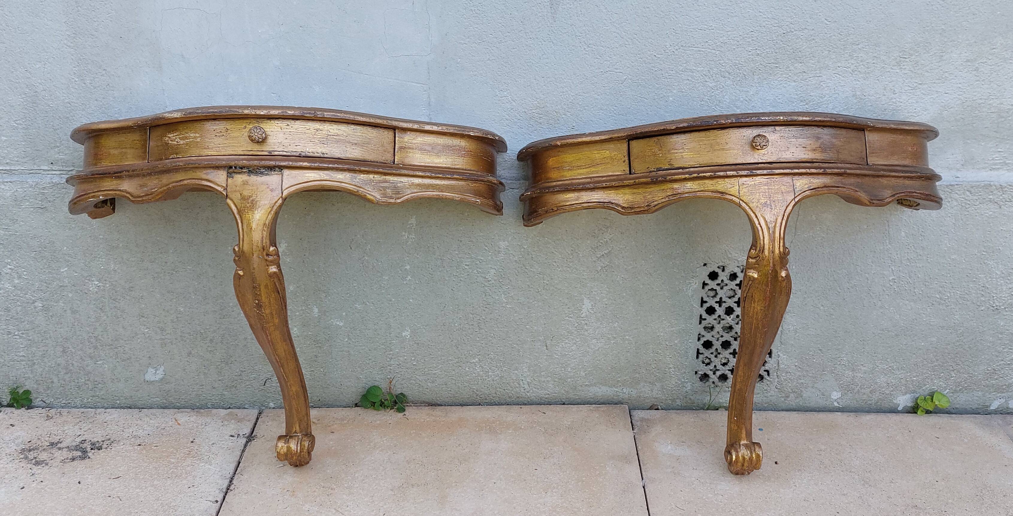 Golden patinated wall consoles