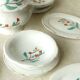 Tableware set in earthenware with floral decoration.