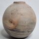 Round ceramic vase with raw finish, smoked firing, signed, late 20th century, 11 cm.