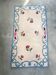 Tapis en laine blanc et bleu fleuri